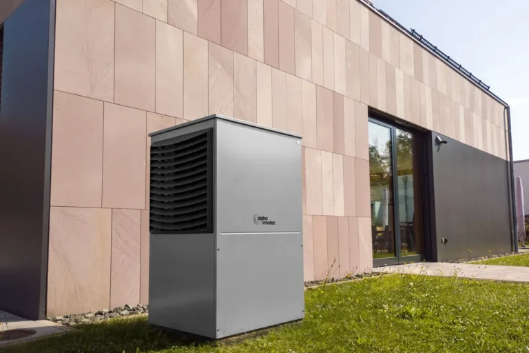 Modern air-source heat pump installed beside a contemporary home