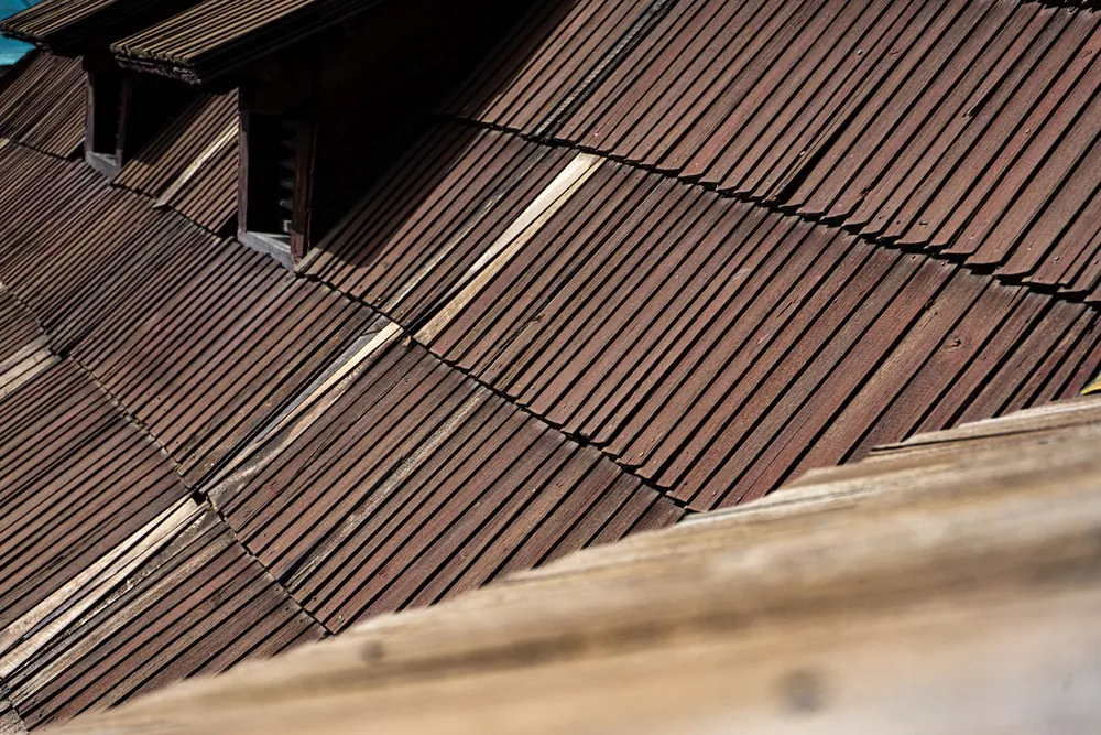 Close-up of wood shingle roofing covering a house roof