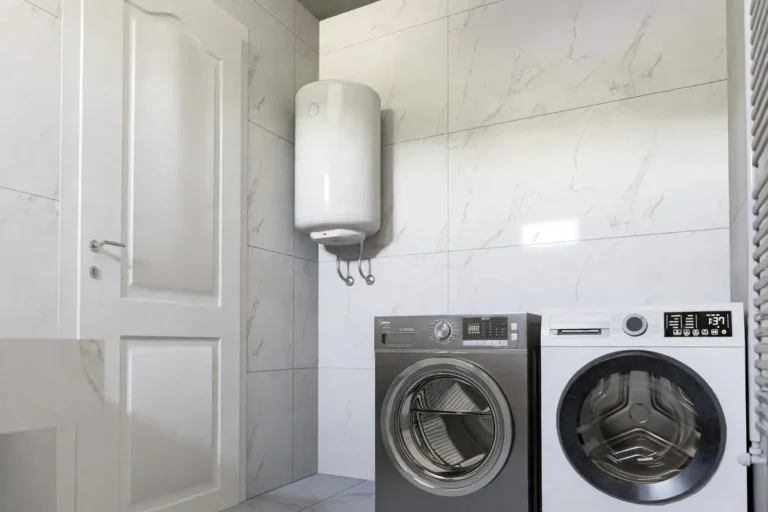 Wall-mounted electric water heater in a tiled laundry room