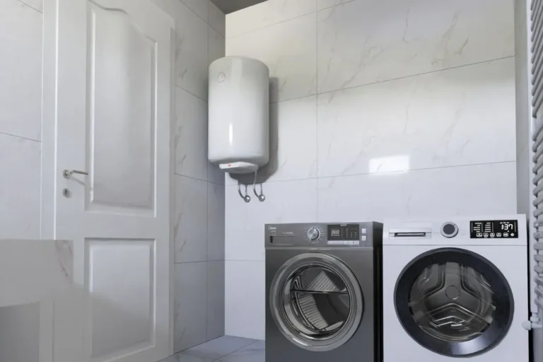 Wall-mounted electric water heater in a tiled laundry room